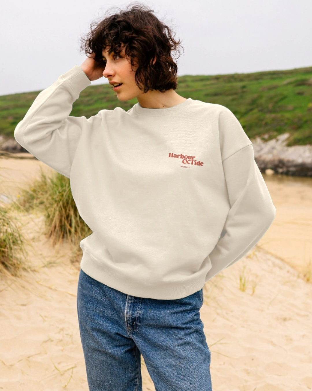 Harbour & Tide Resting Beach Face sweatshirt worn outdoors on beach