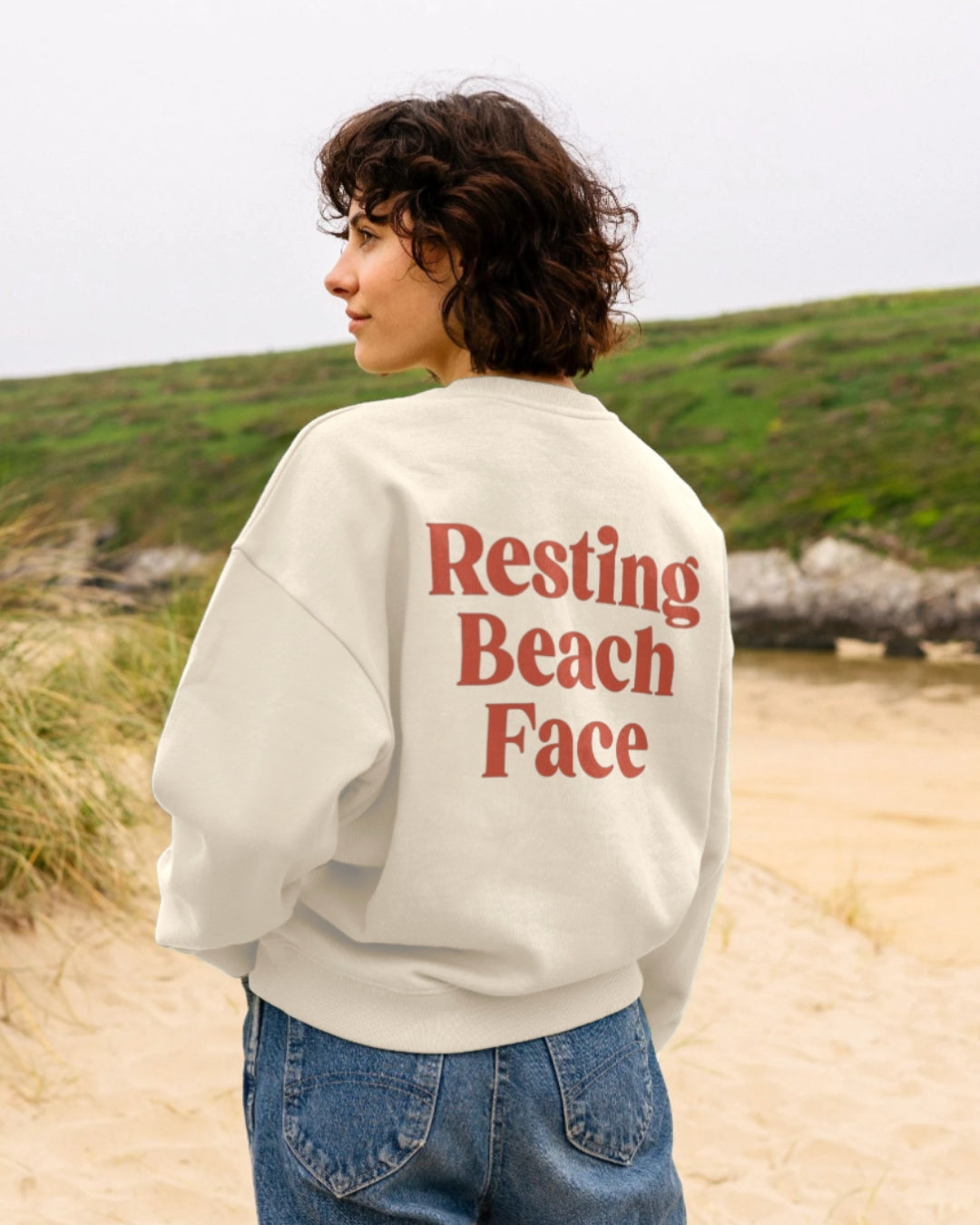 Harbour & Tide Resting Beach Face sweatshirt worn outdoors on beach